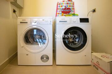 Laundry room with modern washer and dryer