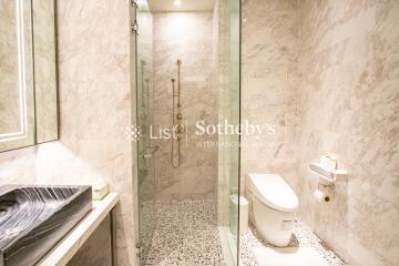 Modern bathroom with marble tiles and glass shower