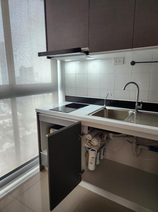 Modern kitchen with sink, cabinets, and induction stove