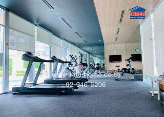 well-equipped gym with cardio machines and cycling stations