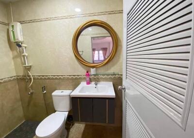 Bathroom with mirror, sink, and toilet