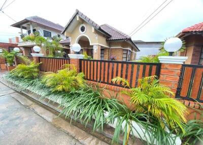 Front of the house with garden and fence