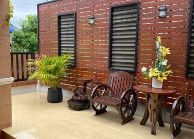 Outdoor patio with wooden furniture and potted plants