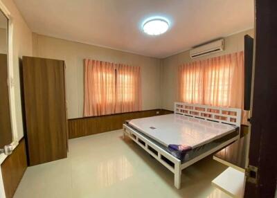 Spacious bedroom with a large bed and ample natural light