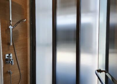 Modern shower stall with glass door and frosted windows