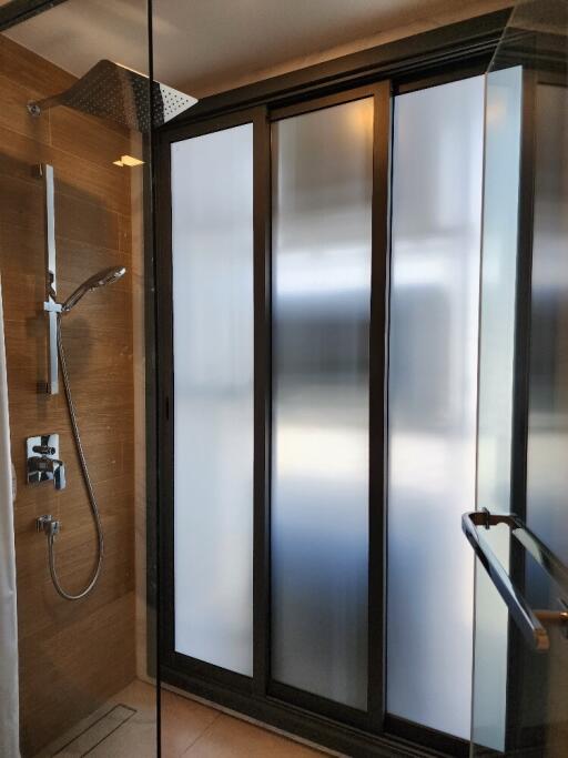 Modern shower stall with glass door and frosted windows