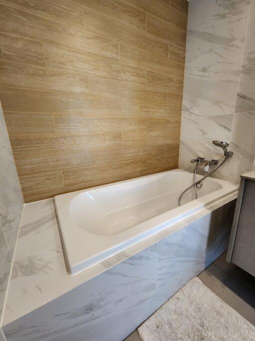 Bathroom with bathtub and modern tiling