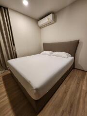 Bedroom with double bed, air conditioning, and wooden flooring