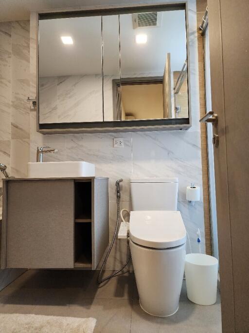 Modern bathroom with vanity, mirror cabinet, and toilet