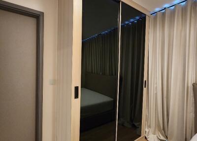 Bedroom with mirrored wardrobe and light curtains