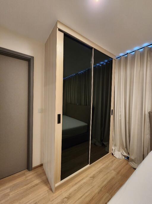 Bedroom with mirrored wardrobe and light curtains