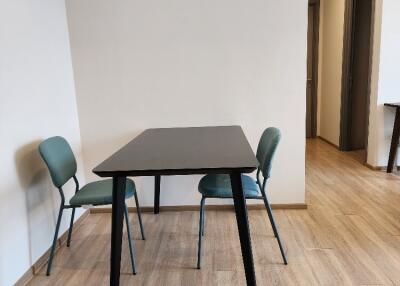 Minimalist dining area with a table and two chairs