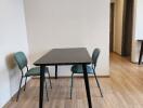 Minimalist dining area with a table and two chairs