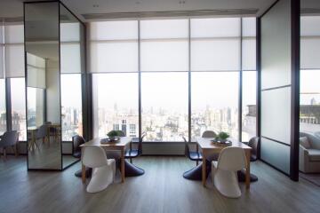 Spacious modern living area with large windows and city view