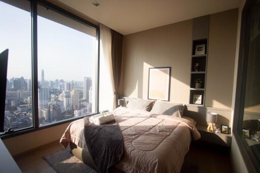 Modern bedroom with large windows and city view