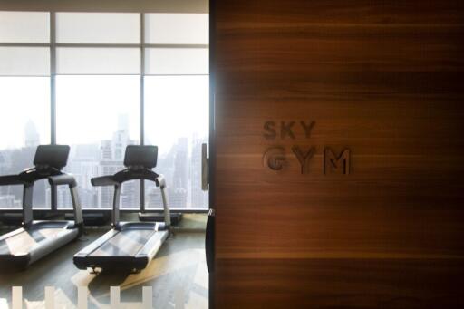 Modern gym with treadmills and city view