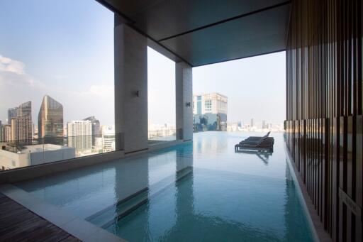 Indoor view of modern building with pool and cityscape