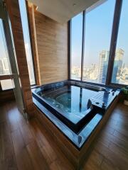 Bathroom with jacuzzi and panoramic city view