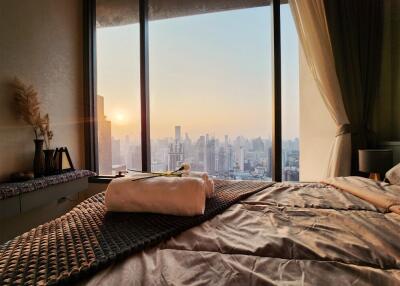 Bedroom with a city view during sunset