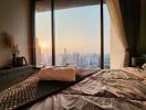 Bedroom with a city view during sunset