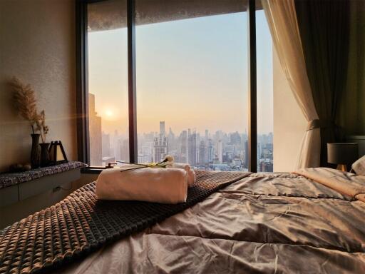 Bedroom with a city view during sunset