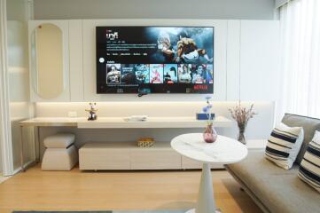 Modern living room with wall-mounted TV and contemporary furniture