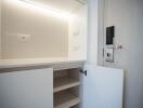 Open storage cabinet with shelves and light