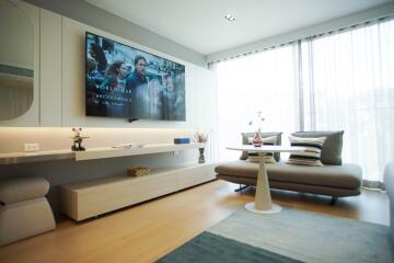 Modern living room with large TV and minimalist design