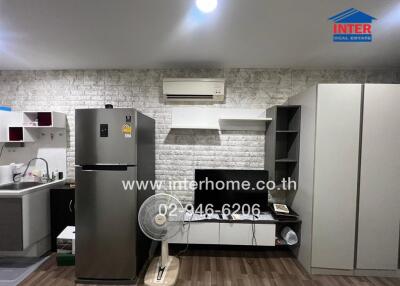 Modern kitchen area with appliances and storage