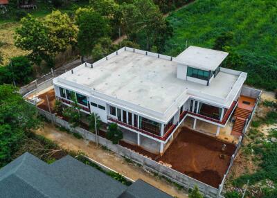 Aerial view of modern building surrounded by greenery