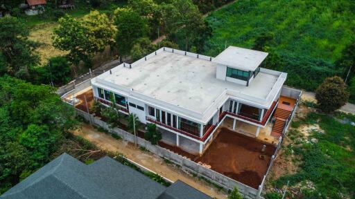 Aerial view of modern building surrounded by greenery