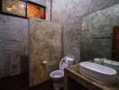 Modern concrete bathroom with large mirror