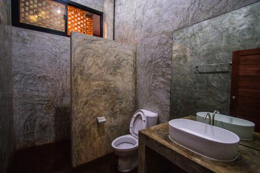 Modern concrete bathroom with large mirror