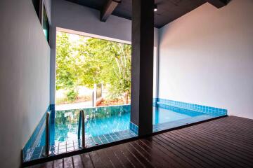 Indoor pool area with blue tiles