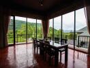 Dining room with large windows overlooking greenery