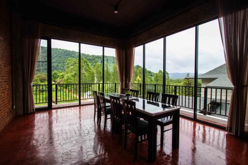 Dining room with large windows overlooking greenery