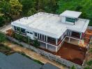 Aerial view of a large modern two-story house with a flat roof