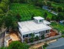 Aerial view of a large modern building with surrounding greenery