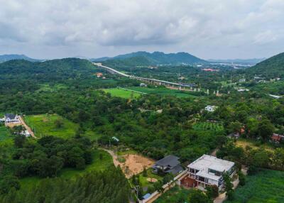 Aerial view of a property amidst green hills