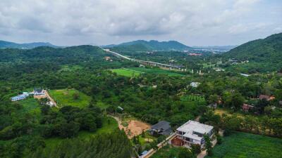 Aerial view of a property amidst green hills