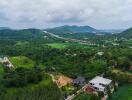 Aerial view of a property amidst green hills