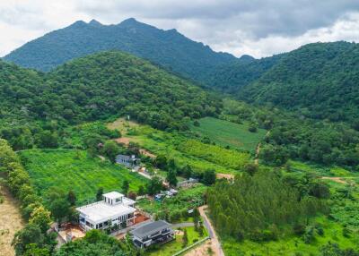 Aerial view of property in lush green mountainous area