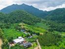 Aerial view of property in lush green mountainous area