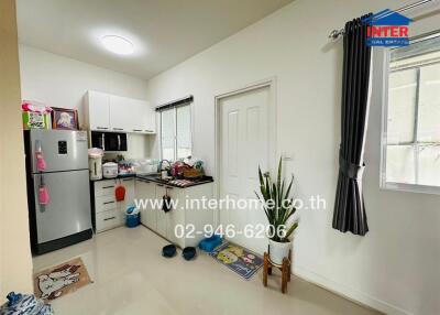 Modern kitchen with appliances and adjoining storage space