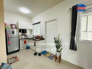 Modern kitchen with appliances and adjoining storage space