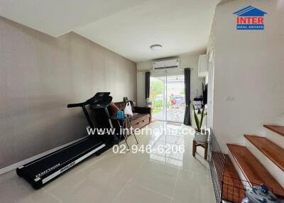 Modern living room with a treadmill and sofa