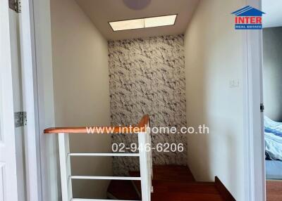 Hallway with stairs and wallpaper