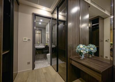 Modern bathroom view with wooden accents and decorative flowers