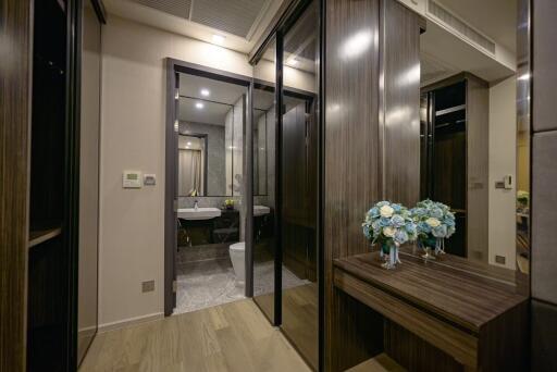 Modern bathroom view with wooden accents and decorative flowers