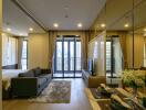 Modern apartment living room with a view of the city, featuring a couch, dining table, and large windows leading to a balcony.